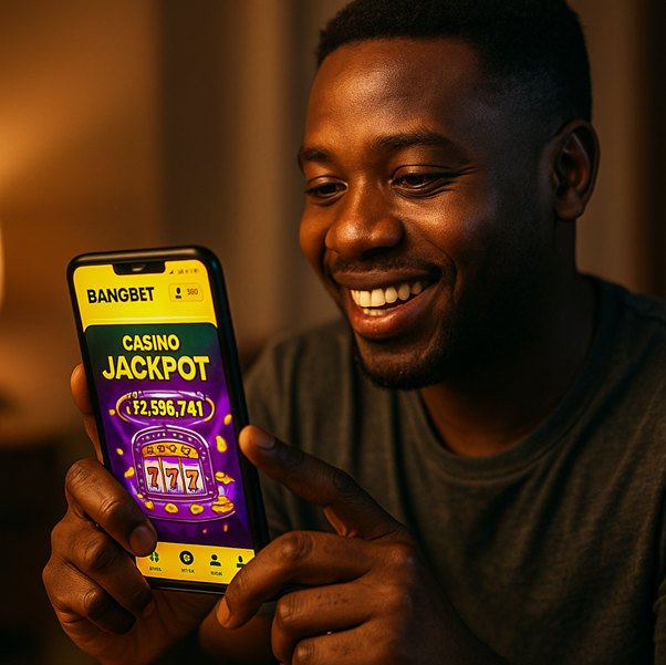 A person holding the phone in his hands, he is smiling because he won on Bangbet